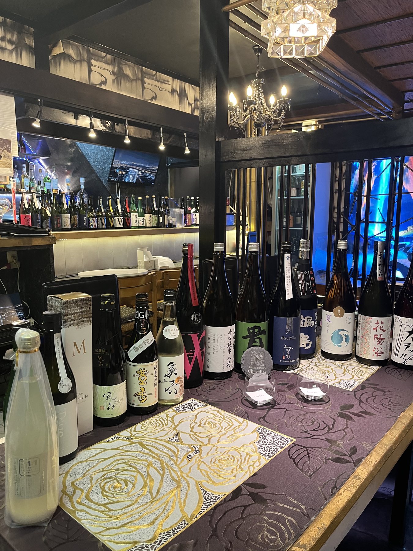 Japanese sake bottles and tasting glasses inside Giludo Chevalier